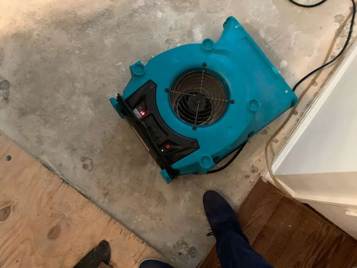 Air mover drying subfloor during Commercial Water Damage Restoration in Northlake